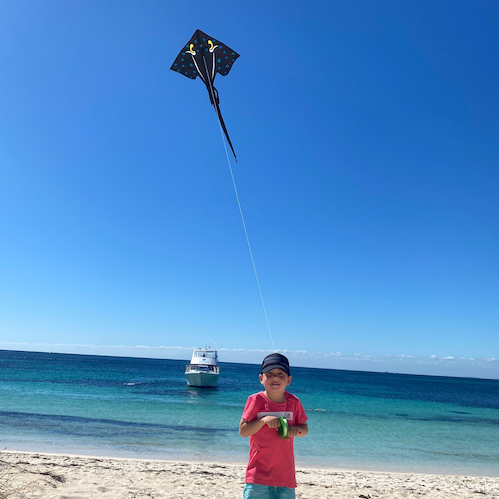 Boy flying the black Stingray kite